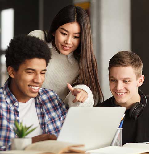 photo of three high school students gathered to discuss school work