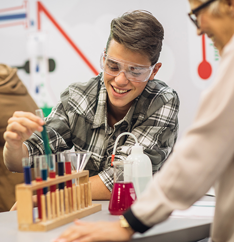 a teacher and student in a chemistry lab