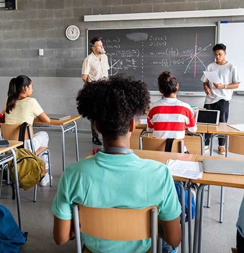 a group of teenage students participating in classroom learning